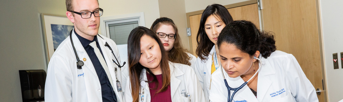 group of five people gathered aroudn patient