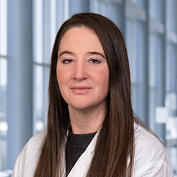 Dr. Ashley, a woman wearing a white coat with long hair