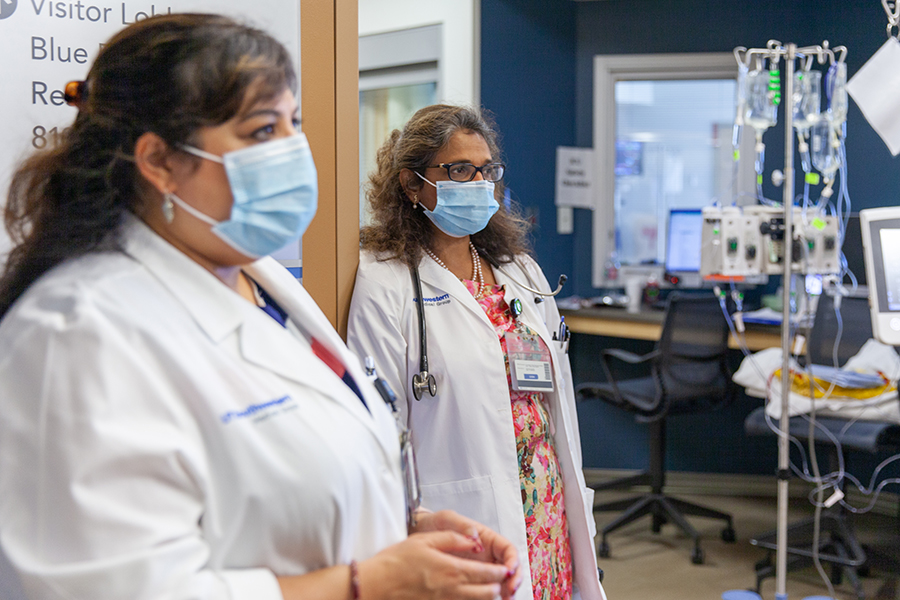 HIV Medicine Fellowship Clinical Training, two doctors with masks on standing in an ICU area