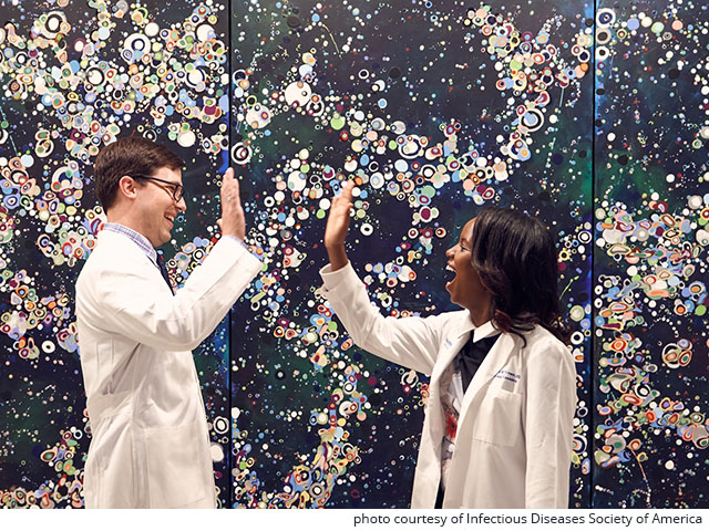 Dr. Brad Cutrell and Dr. Josephine Thinwa giving a high five