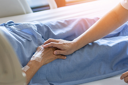 a nusse's hand laying ontop of a fraile patient