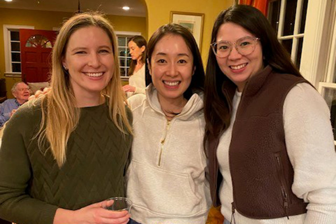 A group shot of three women at a holiday party