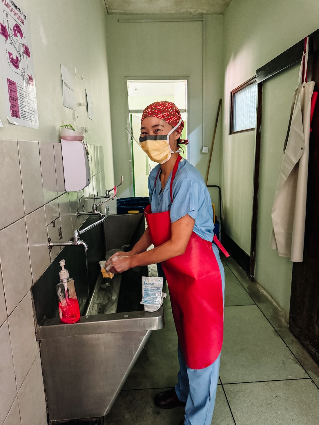 Healthcare worker preparing in scrub area
