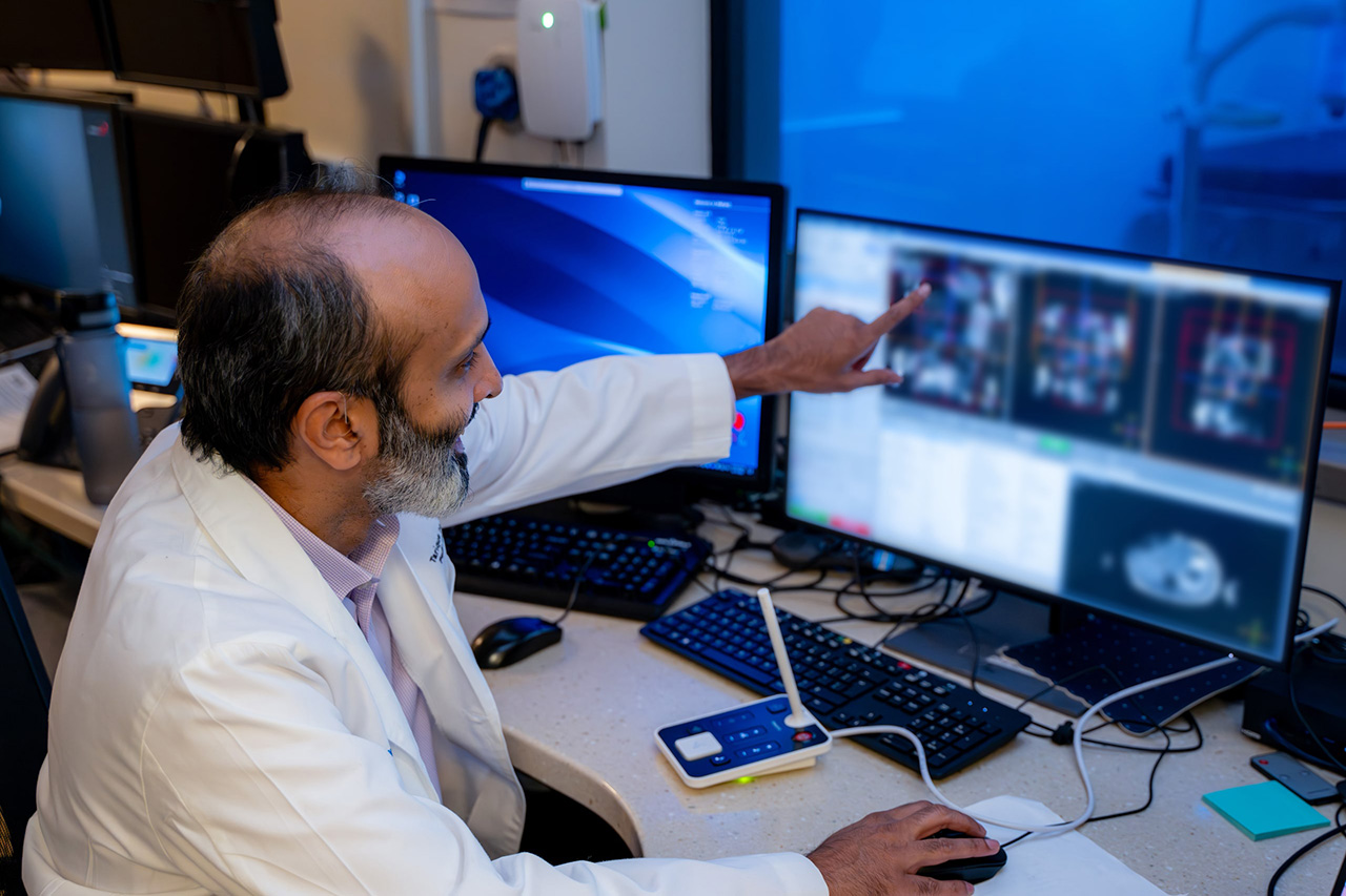 Dr. Hussain looking at an MRI screen