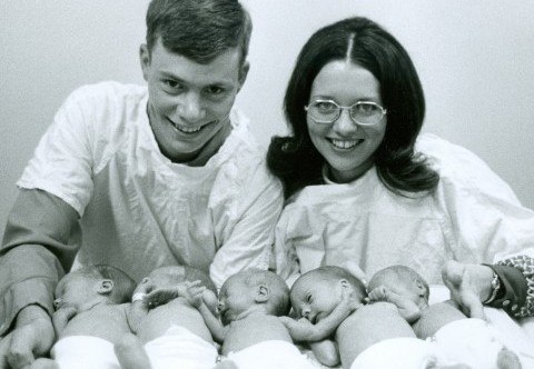Man and woman with their newborn quintuplets