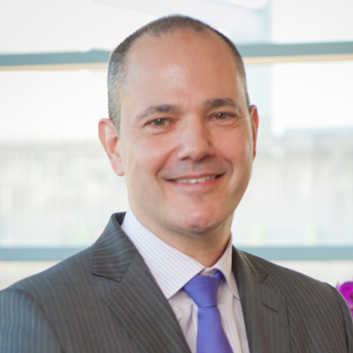 Dr. Rozen, a smiling man with graying hair, wearing a gray suit.