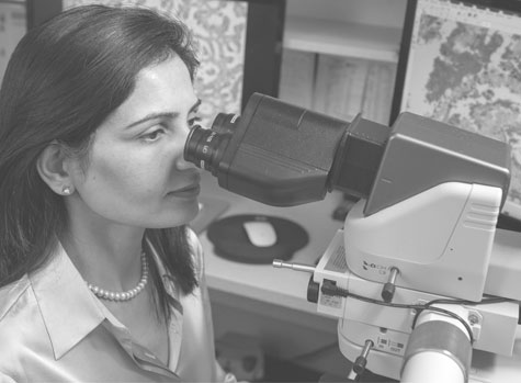 Woman looking through microscope