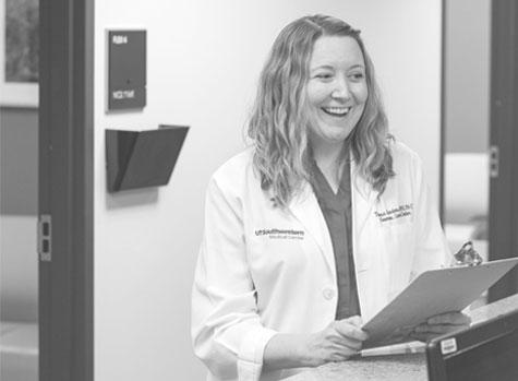 Woman in lab coat holding clipboard