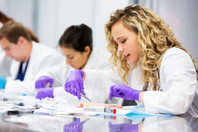 Students learn to suture in the Simulation Center