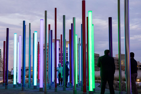 Light tubes of multiple colors reaching from the ground upward