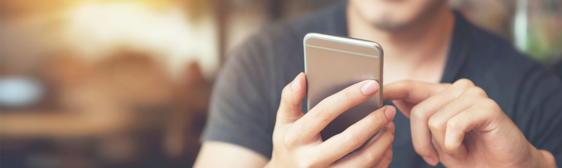 A man touches the screen of his cell phone