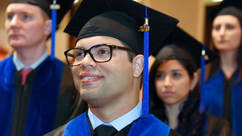 Smiling students in graduation garb