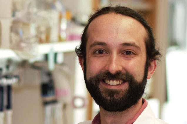 Man with short dark hair, trim beard, smiling