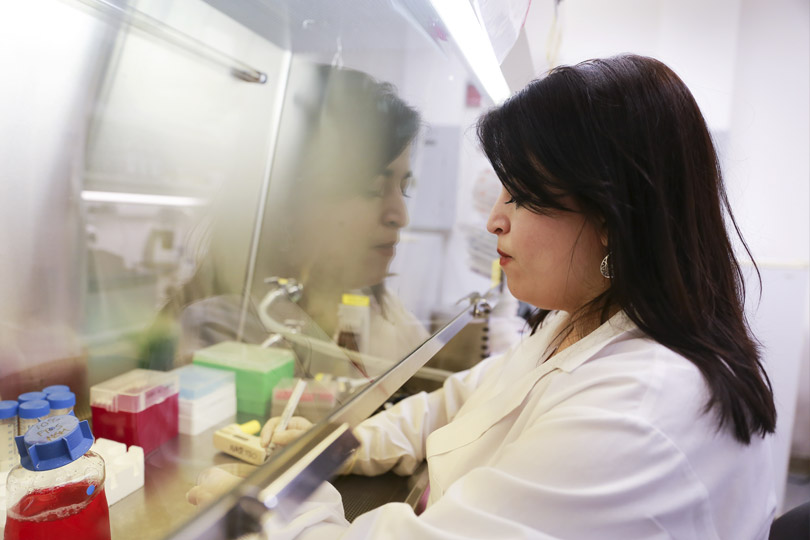 A woman conducts research in the lab