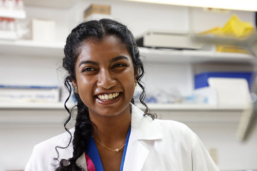 A student checks test tubes in a lab