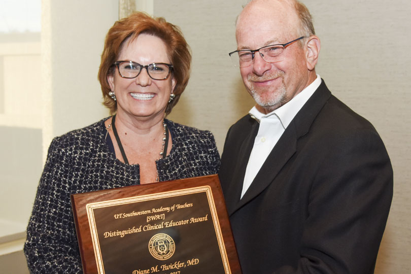 Dr. Greg Fitz gives Dr. Diane Twickler a teaching award