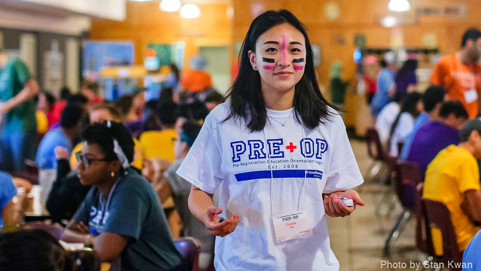 Female student with painted face wearing a t-shirt in the dining hall