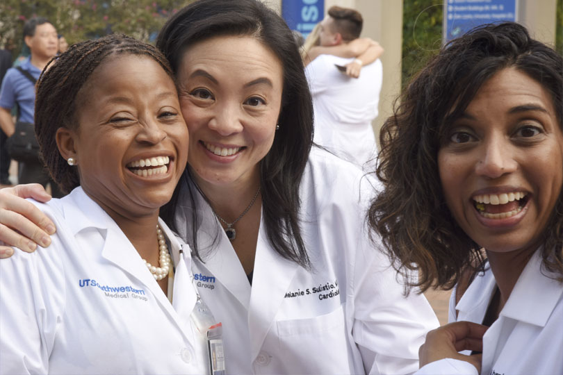 Three faculty and administrators are happy at the White Coat Ceremony 