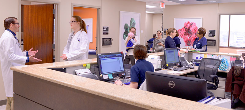 photo of Med-Peds residents, doctors and nurses at clinic station
