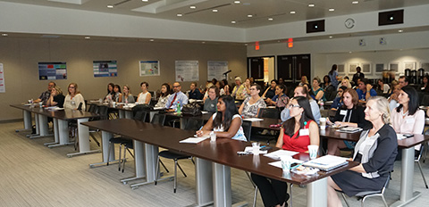 symposium attendees sitting in classroom