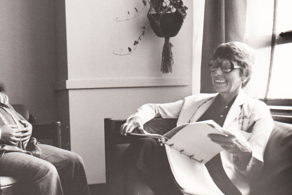 Dr. Whalley meets with a patient in an office