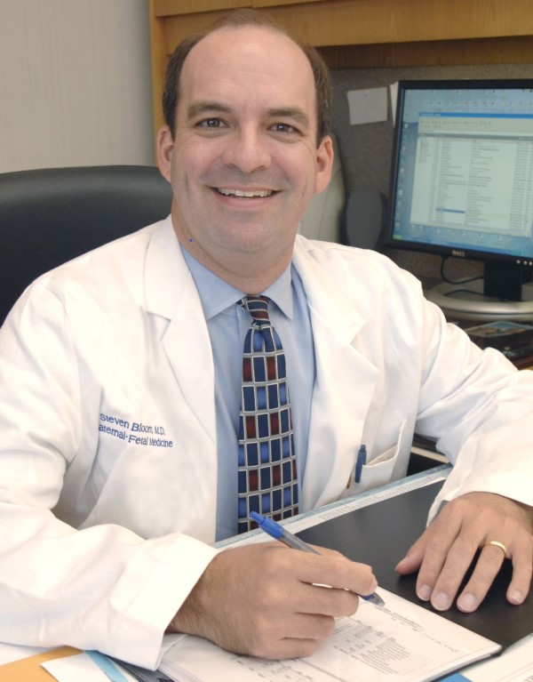 In 2006, the Society for Maternal–Fetal Medicine recognized his achievements with the Research Excellence Award. Dr. Steven L. Bloom at desk in 2006