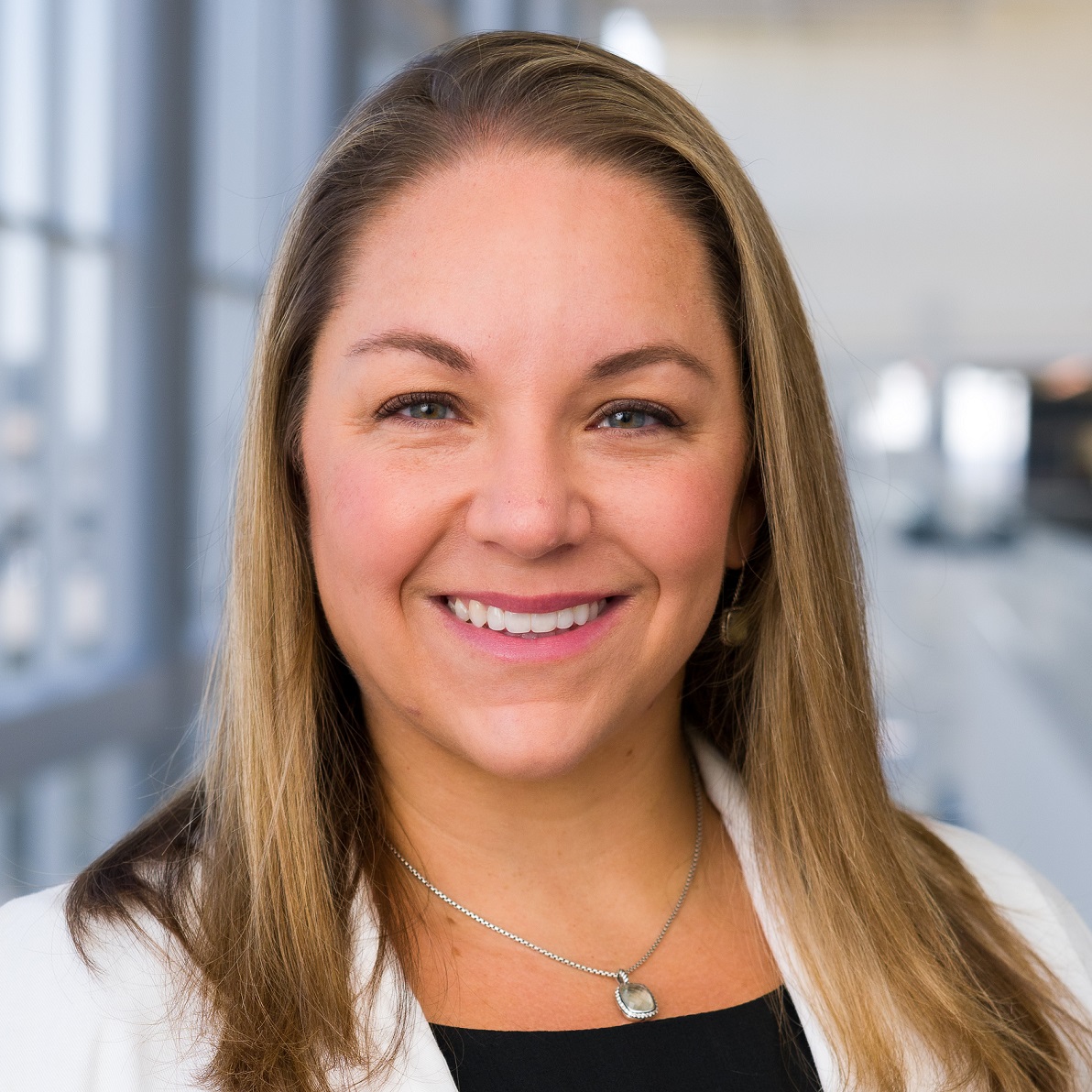 Headshot of woman wearing white coat