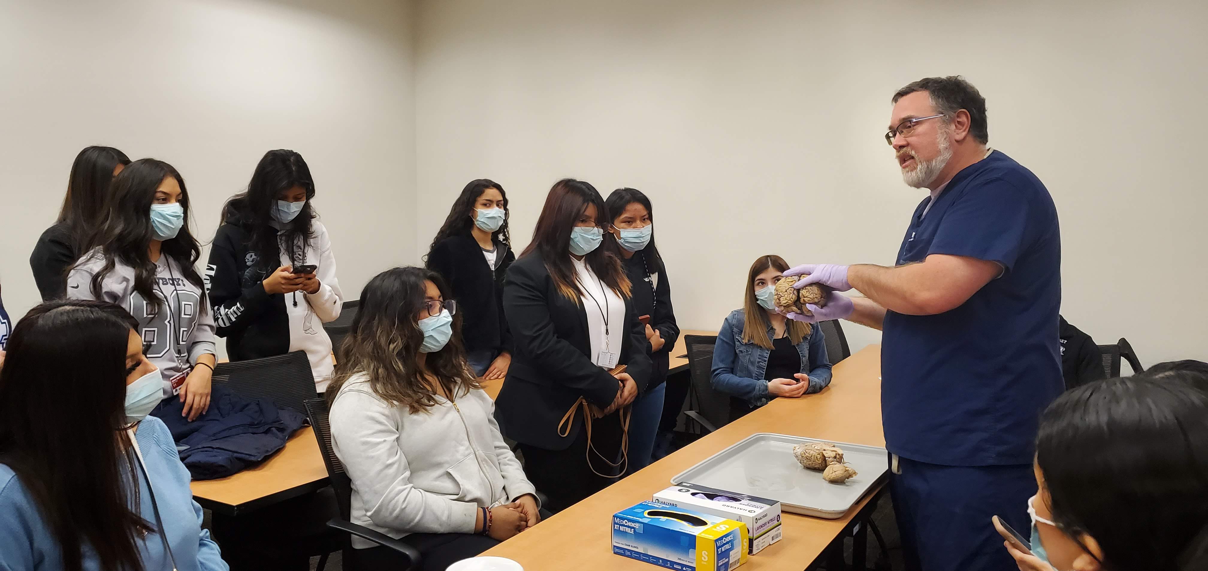 High school students learn about brain histology from neuropathologist Dr. Bret Evers