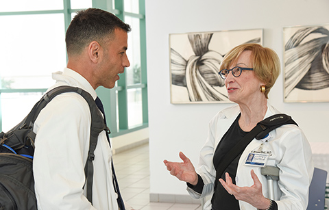 Dr. Kathleen Bell and Chief Resident Dr. Nasser Ayyad discuss a recently published article regarding treatment methods for concussion. Department Chair talking with Chief Resident