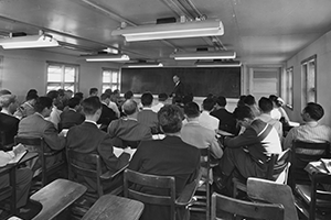 Students seen from behind with Dr. Caldwell in front