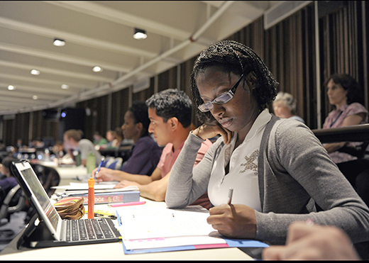 Students taking notes in lecture hall