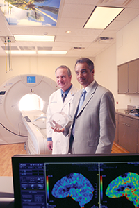 Phil Evans and Mike Medina pose in MRI suite