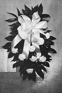 Large arrangement of white flowers with bow