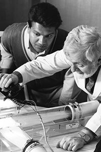 Dr. Antich adjusts equipment as student watches closely