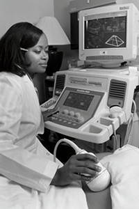 Cecelia Brewington performing a scan on a patient's abdomen