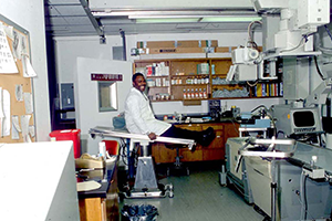 Curtis Chaney sits, smiling, on an exam table