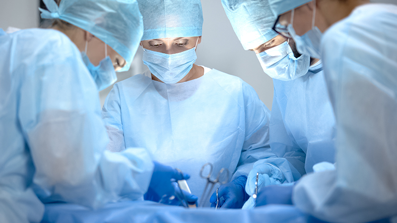 Four surgeons perform surgery
