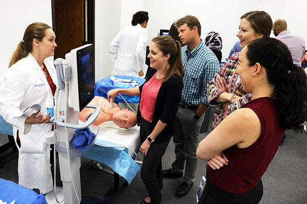 Assistant Professor Sarah Oltmann, M.D., guides first-year residents during a central line placement training class.