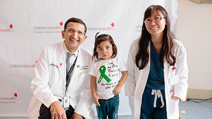 Dev Desai, M.D., and Christine Hwang, M.D., with pediatric transplant patient