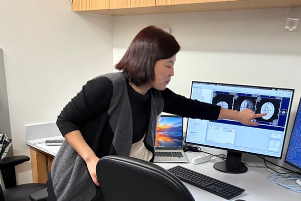 STARS instructor pointing to a comupter screen, viewing an X-ray