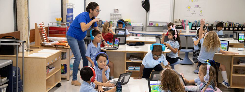 Female teacher instructing students in classroom