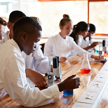 Male and female middle schoolers in science class