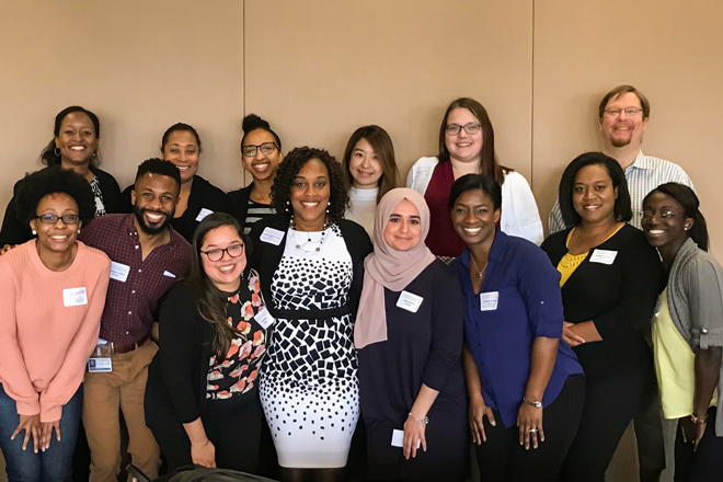 Dr. Carolyn Bradley-Guidry surrounded by about 13 diverse students