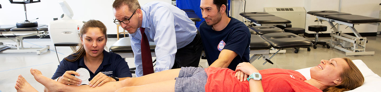 A student takes measurements on a patient's lower leg