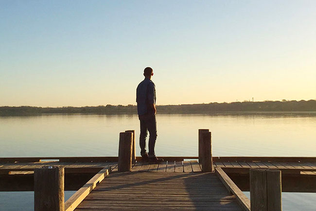 Person on boat dock overlooking calm White Rock Lake