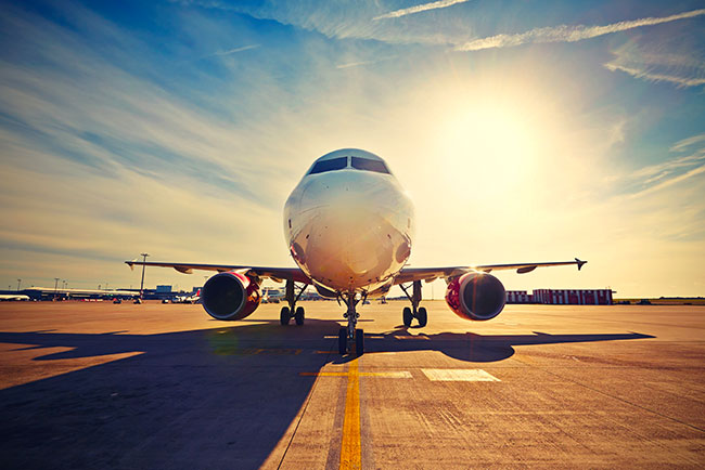 Photograph of a passenger airplane parked from the front-view