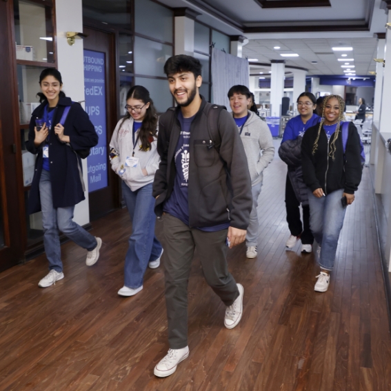 Group of students walking down hallway