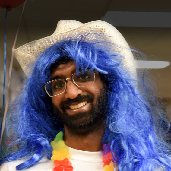 Student with cowboy hat, blue hair, and colorful lei