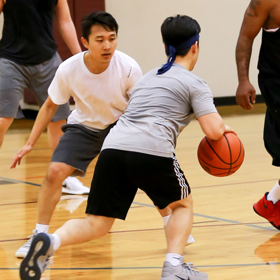 Two students playing basketball