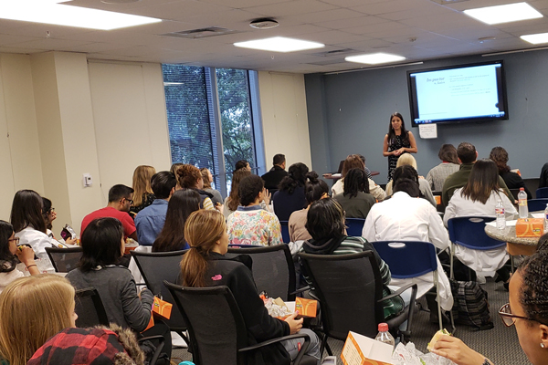 A woman addressing a classroom of learners